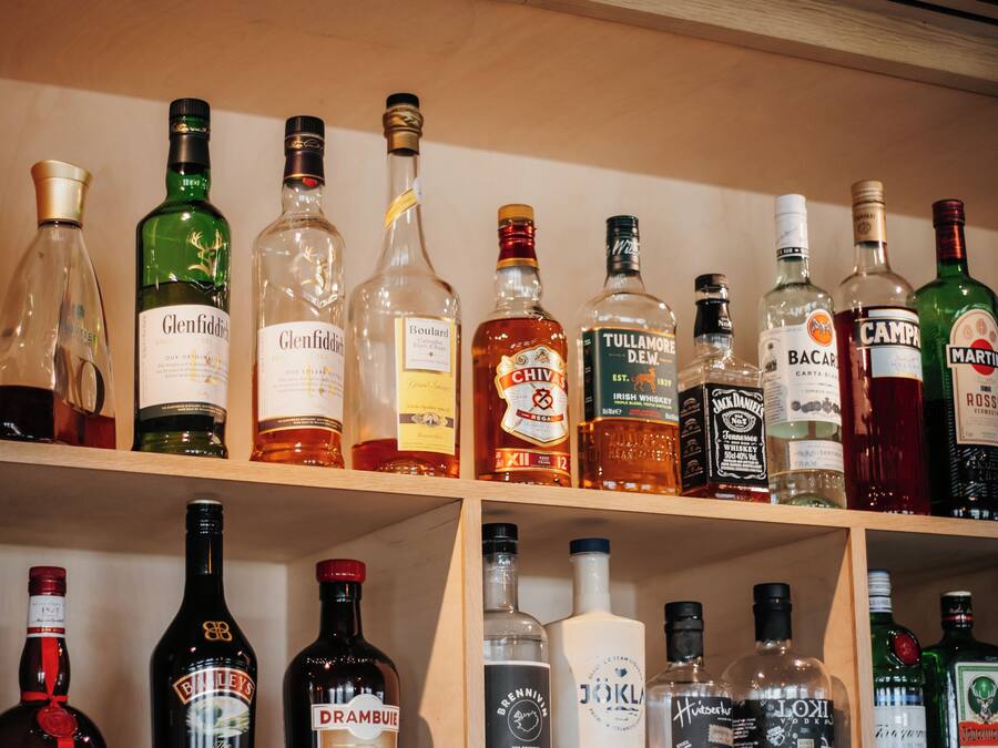 A variety of liquor bottles arranged on shelves.