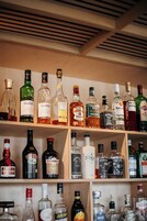 Variedad de botellas de licor dispuestas en estantes.