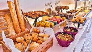 A buffet with various breads, pastries, and desserts. - Paradiso Ibiza Art Hotel - Adults Only (Sant Josep de sa Talaia)