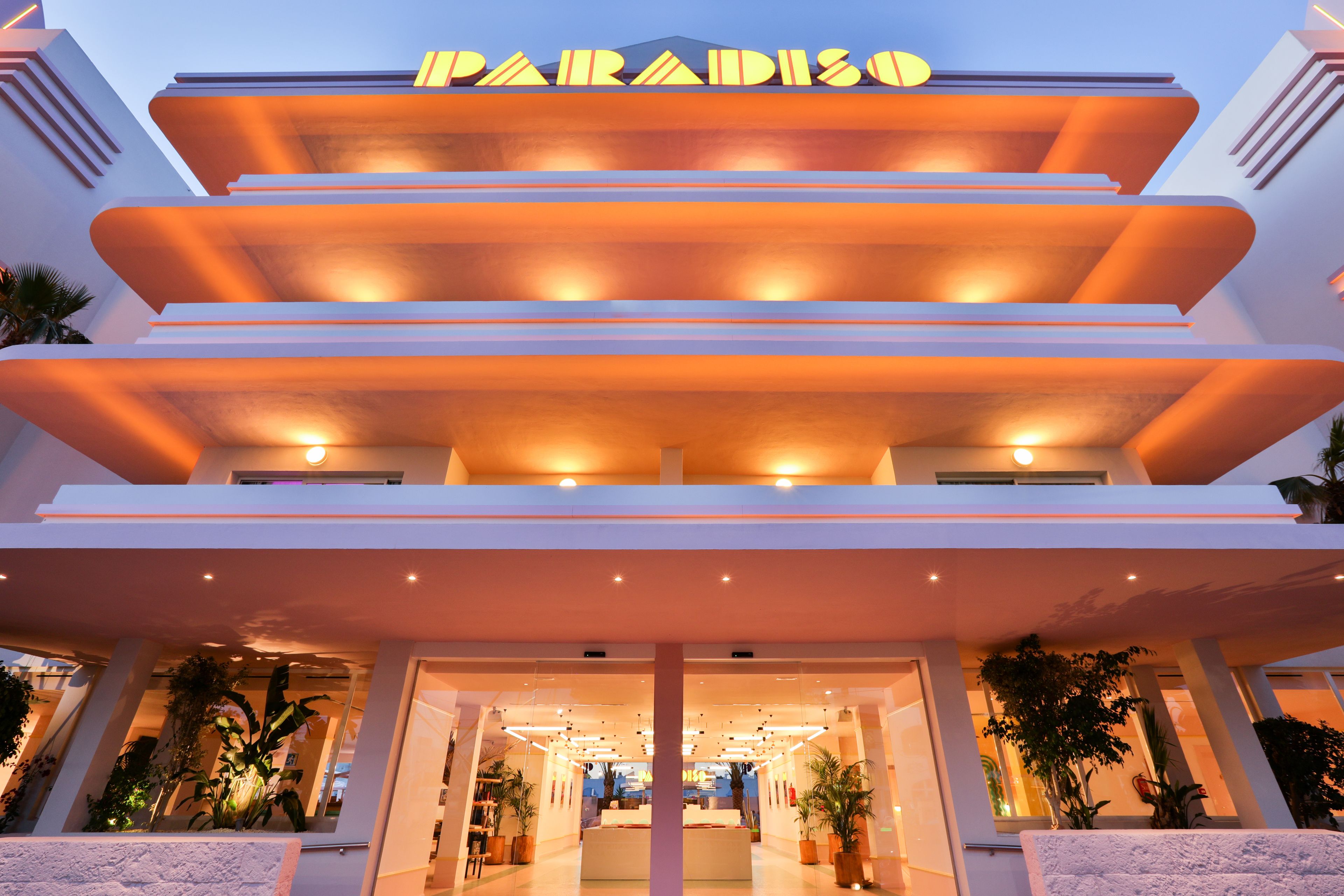 A multi-story hotel with a modern design, featuring a prominent sign at the top.