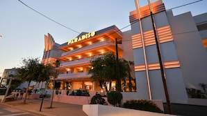 A modern hotel with a prominent 'PARADISO' sign, featuring a multi-story structure with balconies and a well-lit facade. - Paradiso Ibiza Art Hotel - Adults Only (Sant Josep de sa Talaia)