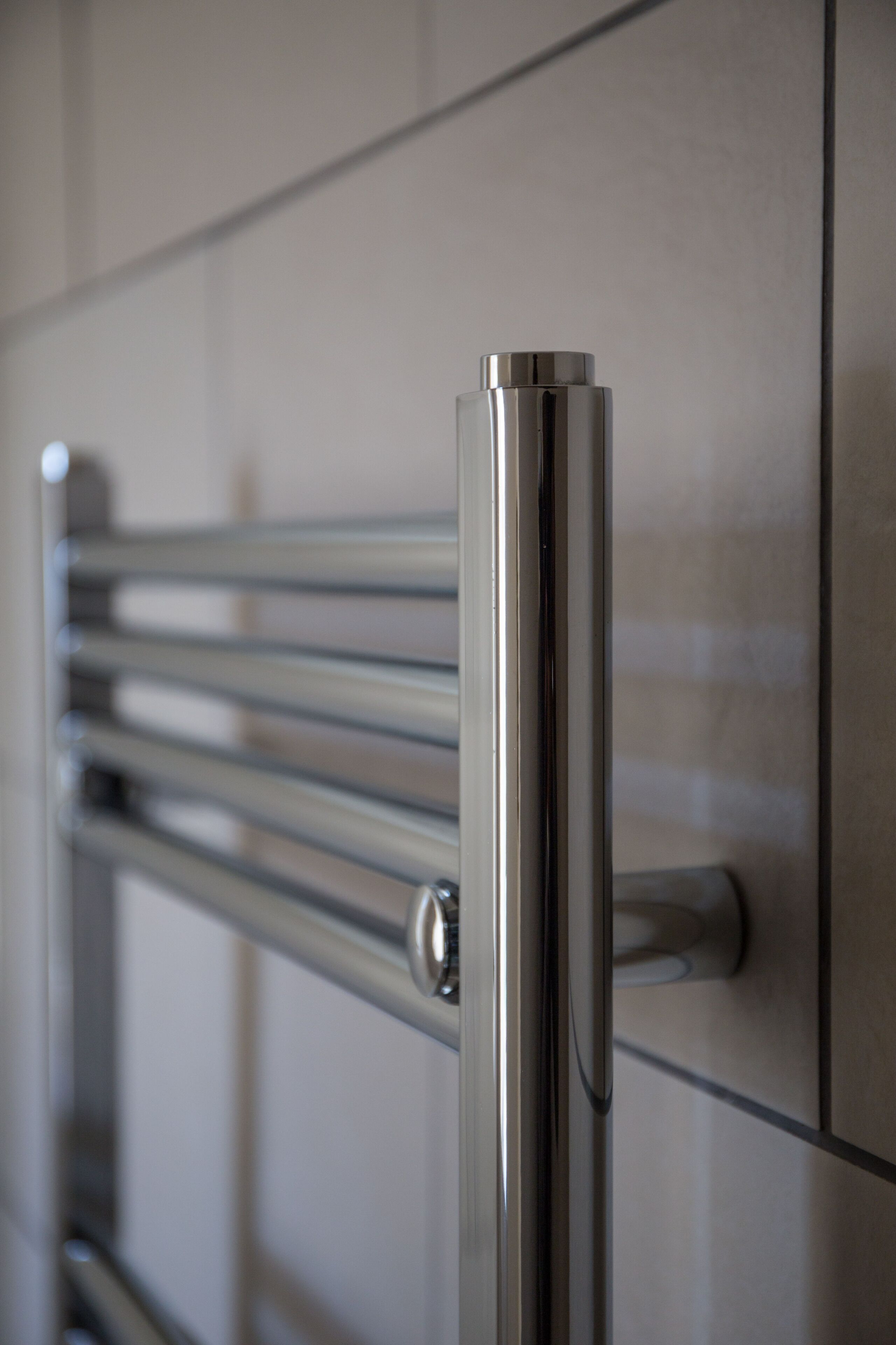 Een metalen handdoekrek met horizontale stangen, waarschijnlijk in een badkamer.