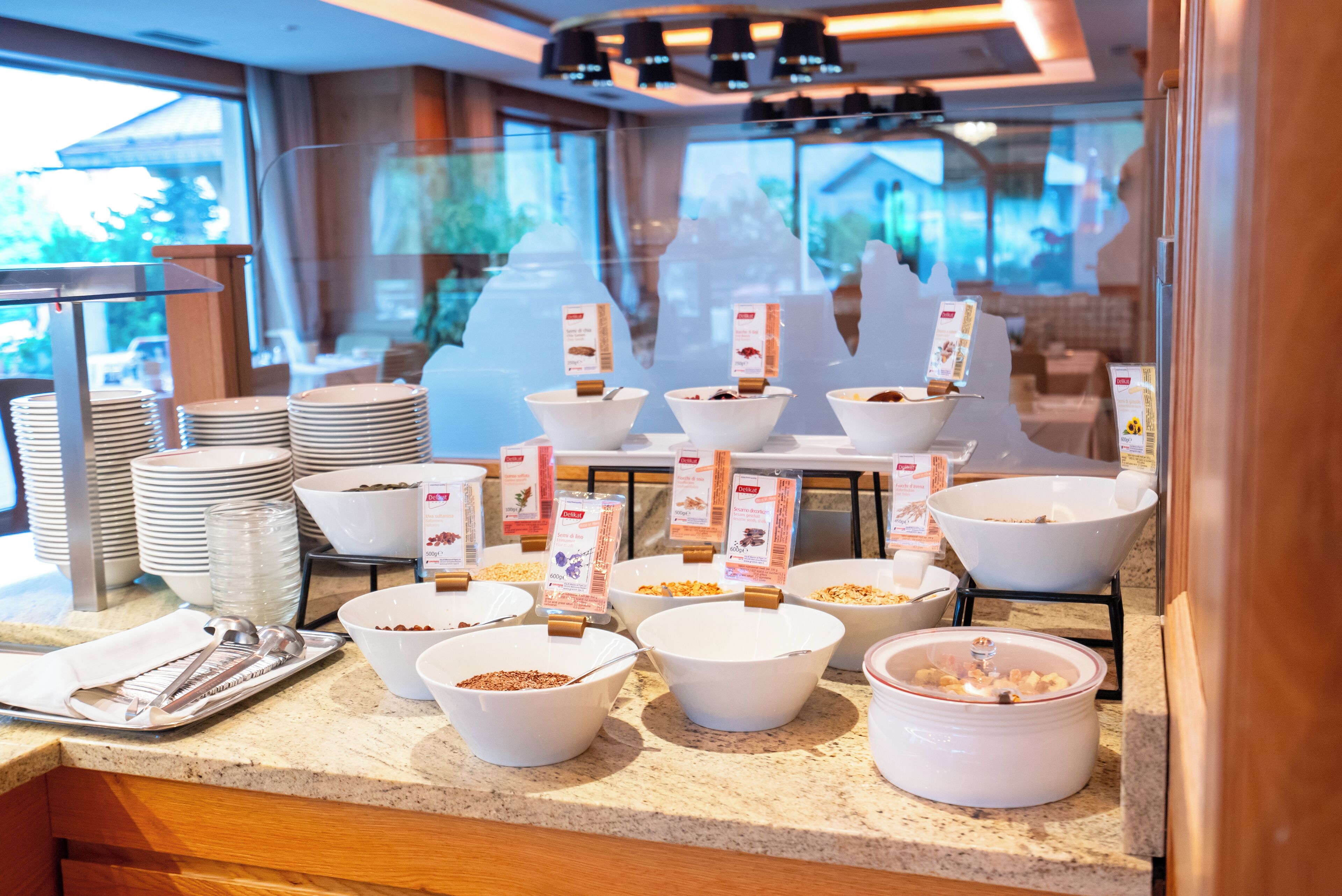 A buffet setup with various food items and serving utensils.
