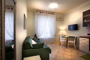 Apartment, 1 Bedroom | Living room | Flat-screen TV