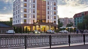 A multi-story hotel with a prominent entrance and balconies. - The Plaza Hotel (Almaty)