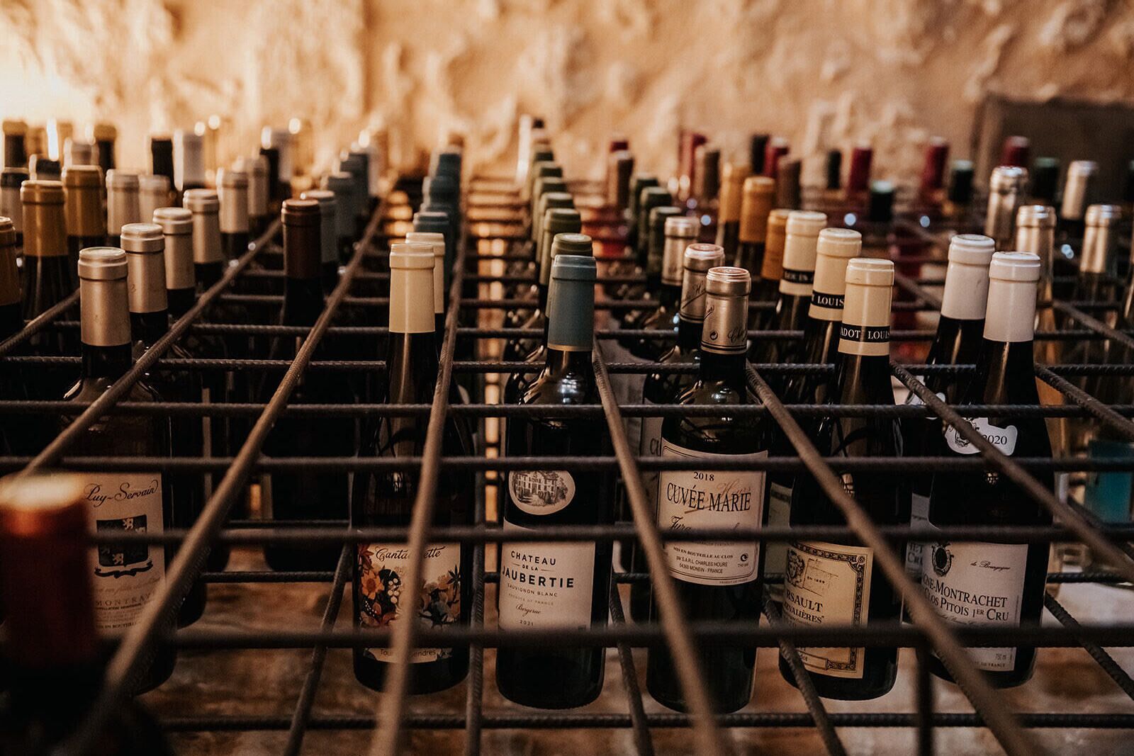 A wine cellar with rows of wine bottles on racks.