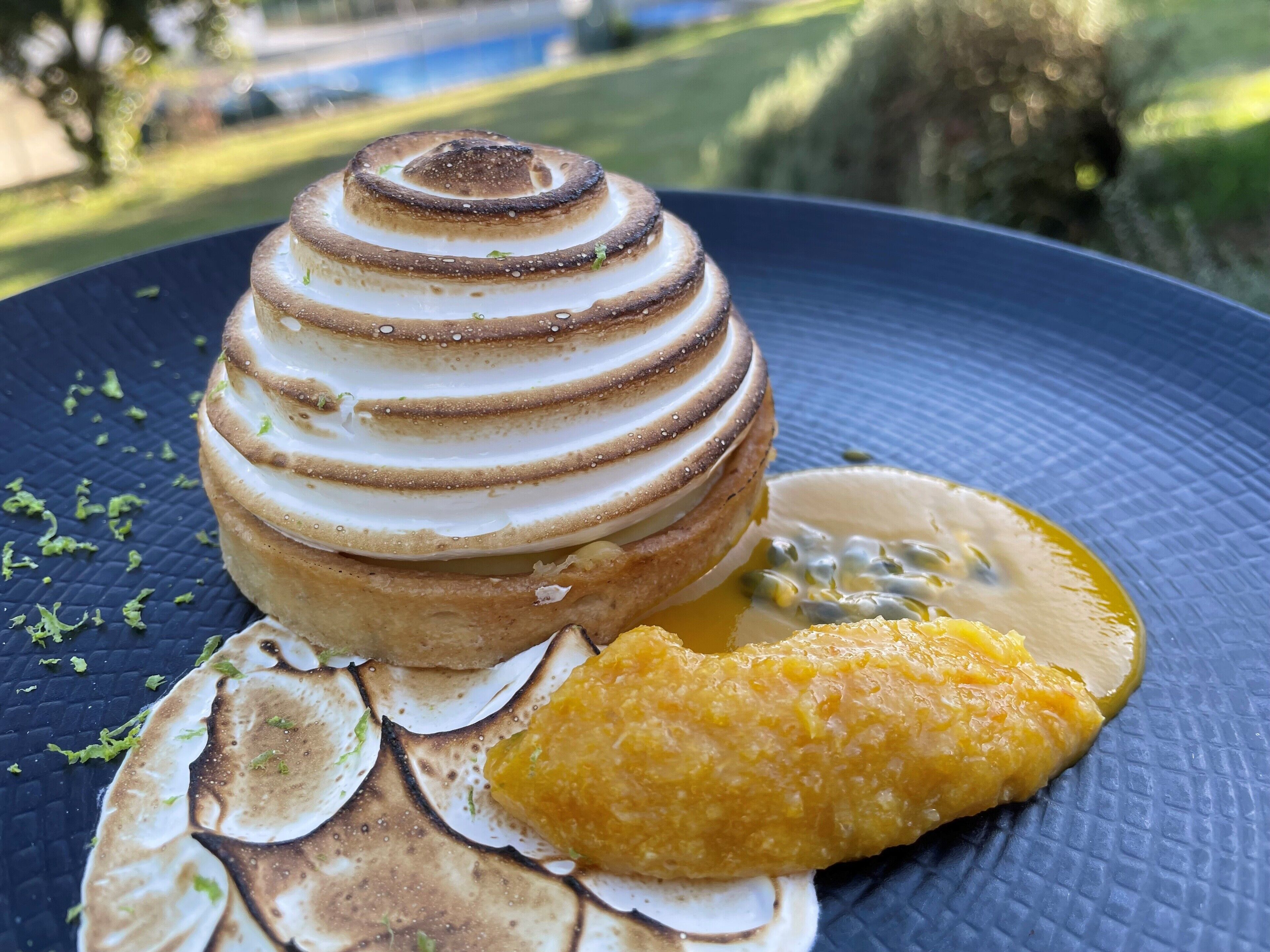 A dessert on a plate with a blue textured background.