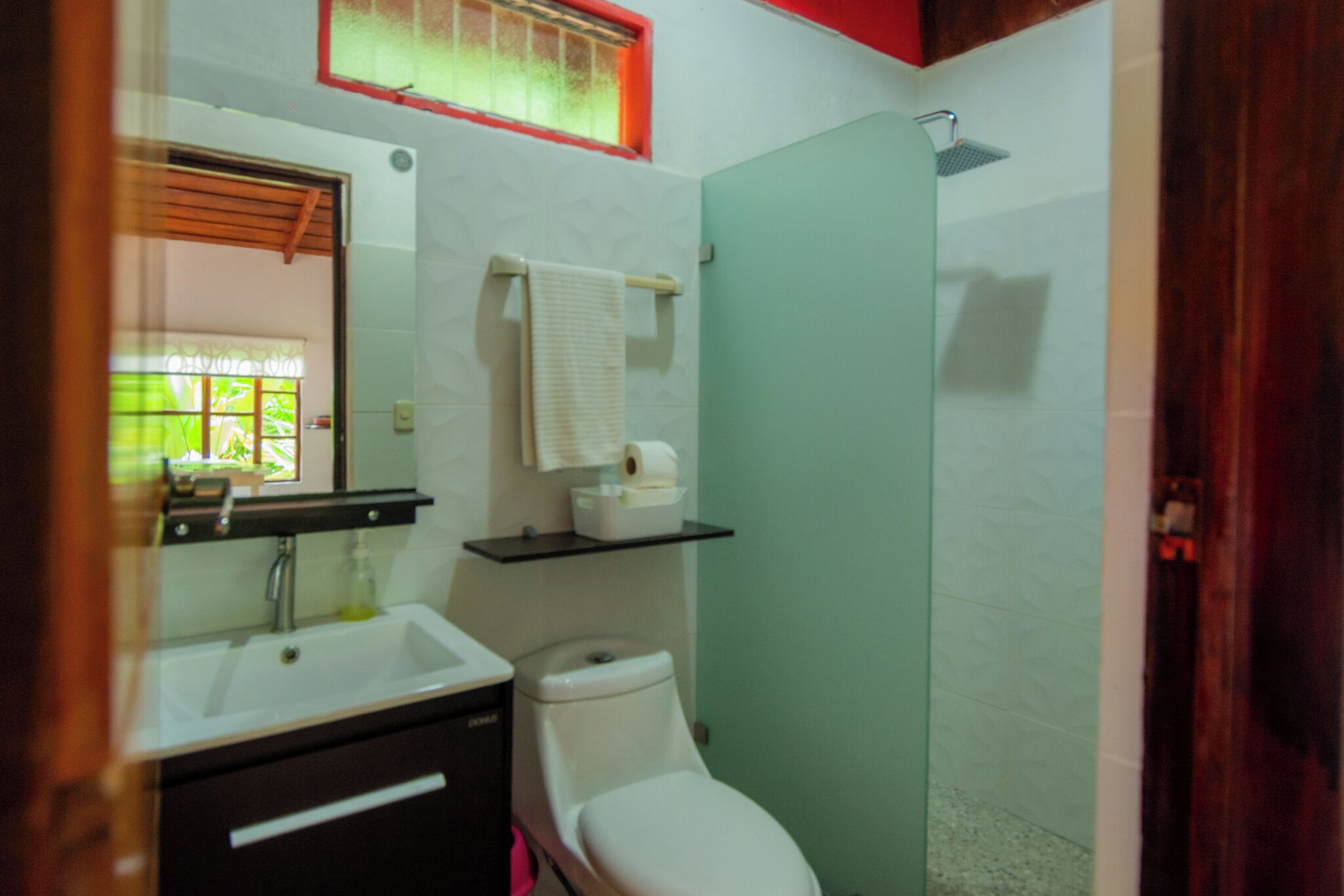 A bathroom with a sink, toilet, and shower.