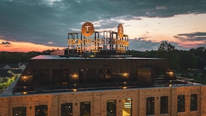 A hotel with a rooftop deck featuring a large sign reading "IRONWORKS HOTEL."