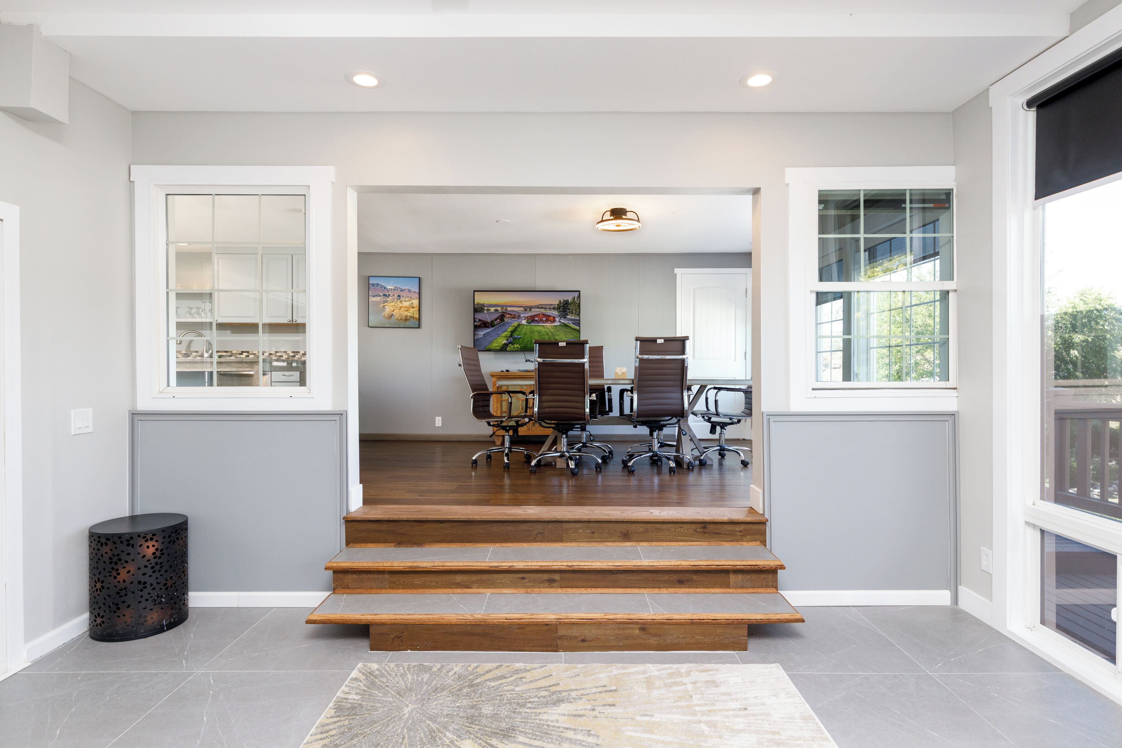 A modern interior with a staircase leading to a dining area.