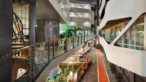 A multi-level atrium with glass railings, seating areas, and a central water feature. - Days Inn & Suites by Wyndham Bengaluru Whitefield (Bengaluru)