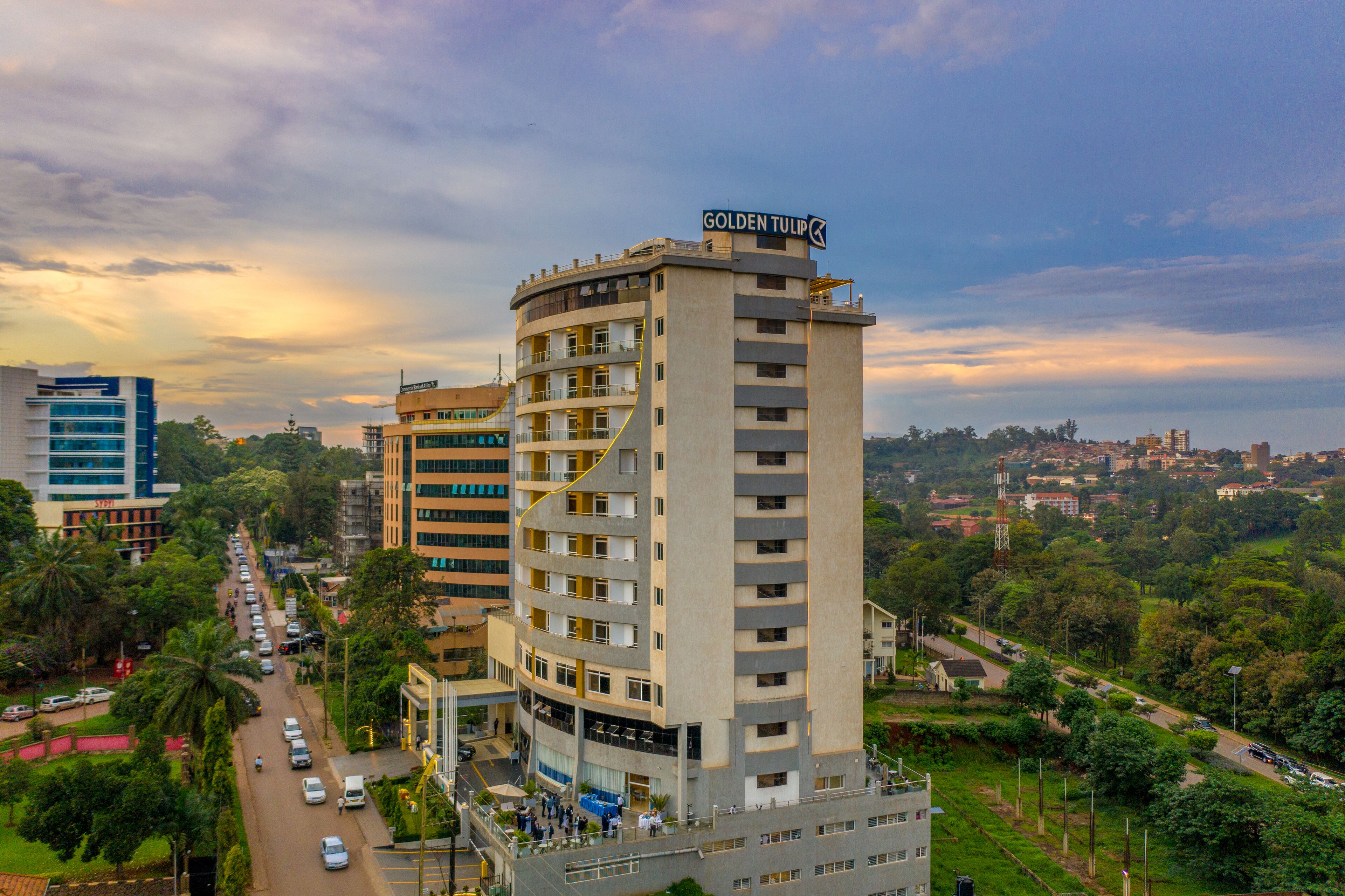 A multi-story hotel with a prominent sign reading "Golden Tulip." It features a modern architectural design with balconies on each floor.