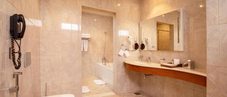 Un baño moderno con inodoro, lavamanos y ducha.