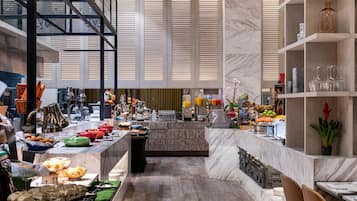 A buffet setup with various food items and beverages.