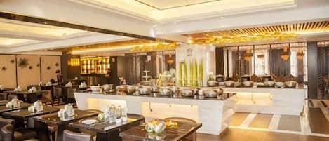 A modern hotel lobby with a central bar area, seating arrangements, and a reception desk.