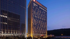 A high-rise building with the name "RAMADA" prominently displayed on the facade.