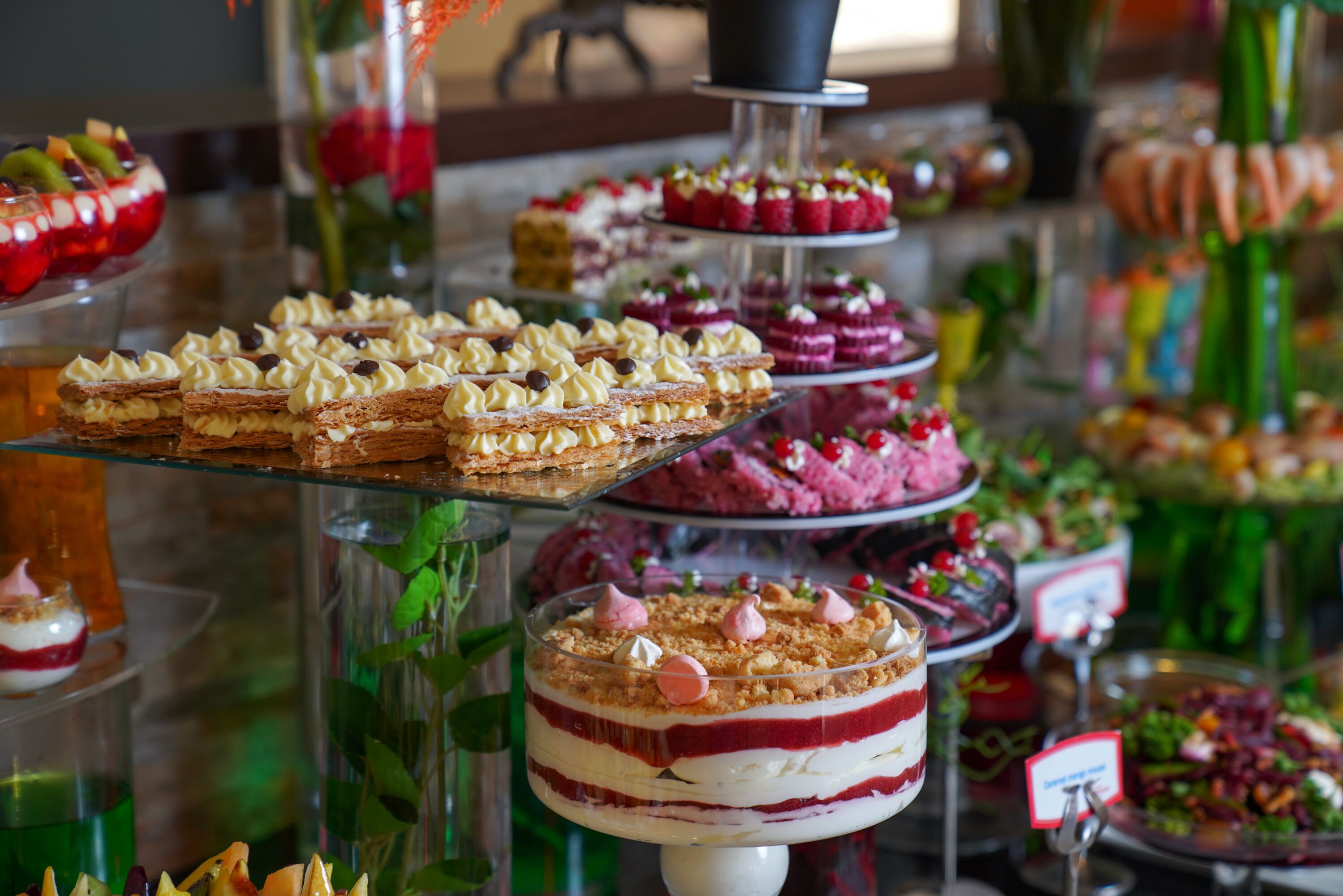A dessert display with various cakes and pastries.