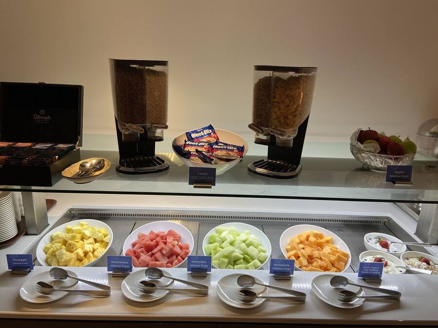 A breakfast buffet with various food options and coffee machines.