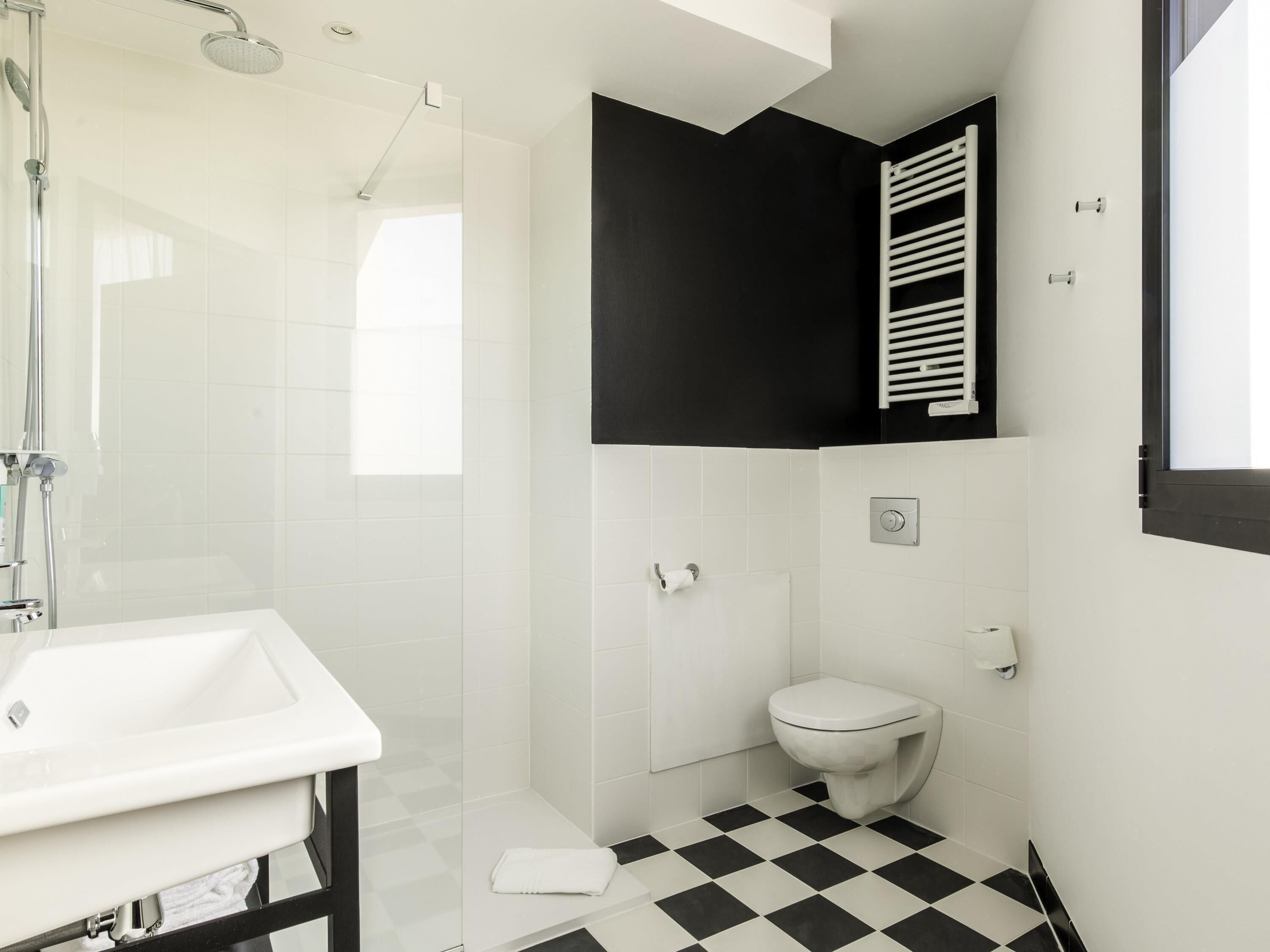 Un baño con ducha, inodoro y lavamanos.