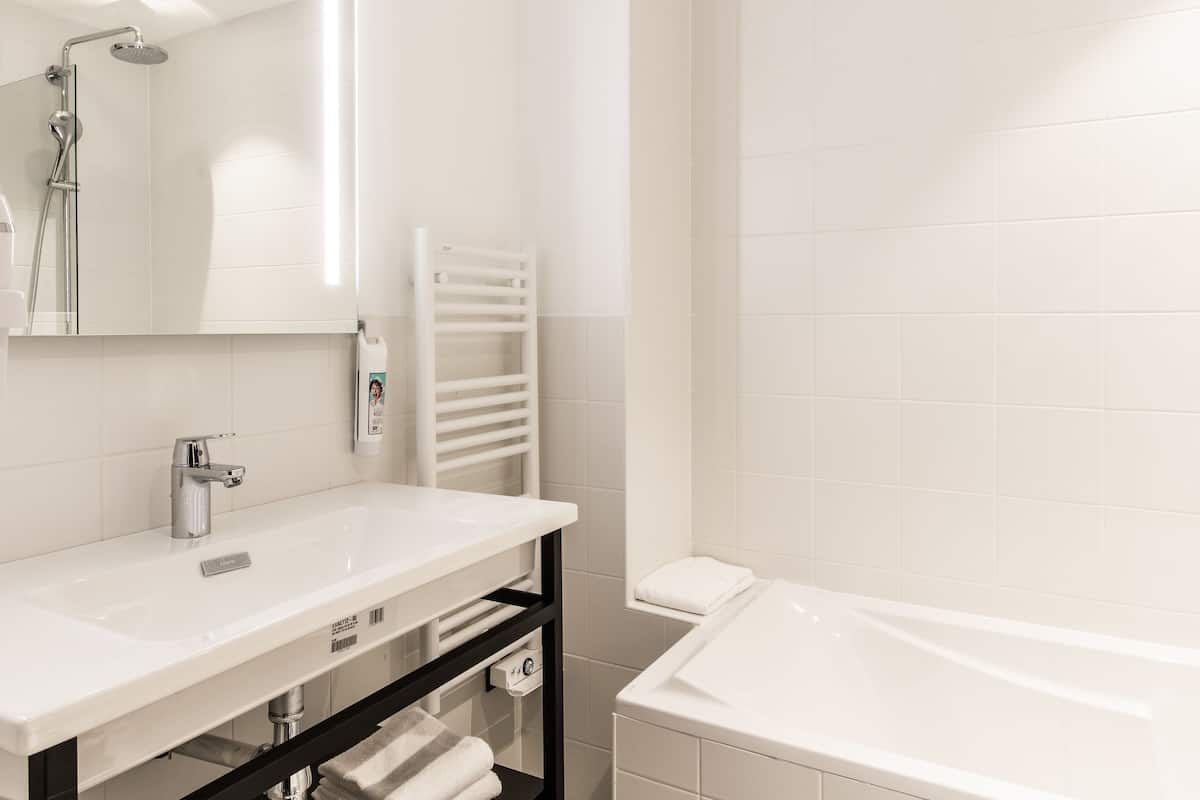 standard room, 2 single beds | bathroom | rainfall showerhead, eco-friendly toiletries, hair dryer, towels