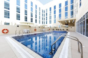 Outdoor pool, open 7:00 AM to 9:00 PM, pool umbrellas, pool loungers - Premier Inn Doha Education City (Al Rayyan)