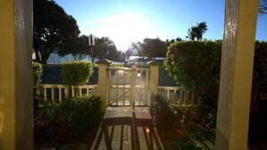 A gated entrance with a clear view of the sky and trees.