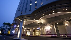 A modern hotel entrance with a curved facade, large columns, and a well-lit entrance area. - Rembrandt Hotel Oita (Oita)