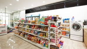 A grocery store with shelves stocked with snacks and packaged goods.