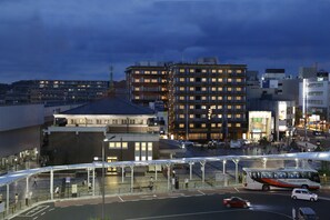 A modern urban area with a bus station, a multi-story building, and a clear sky. - Onyado Nono Nara Natural Hot Spring (Nara)