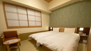 A hotel room with a large bed, a chair, a small table, and a window with a view. - Onyado Nono Nara Natural Hot Spring (Nara)