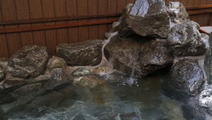A clear water feature with rocks and a wooden backdrop. - Onyado Nono Nara Natural Hot Spring (Nara)