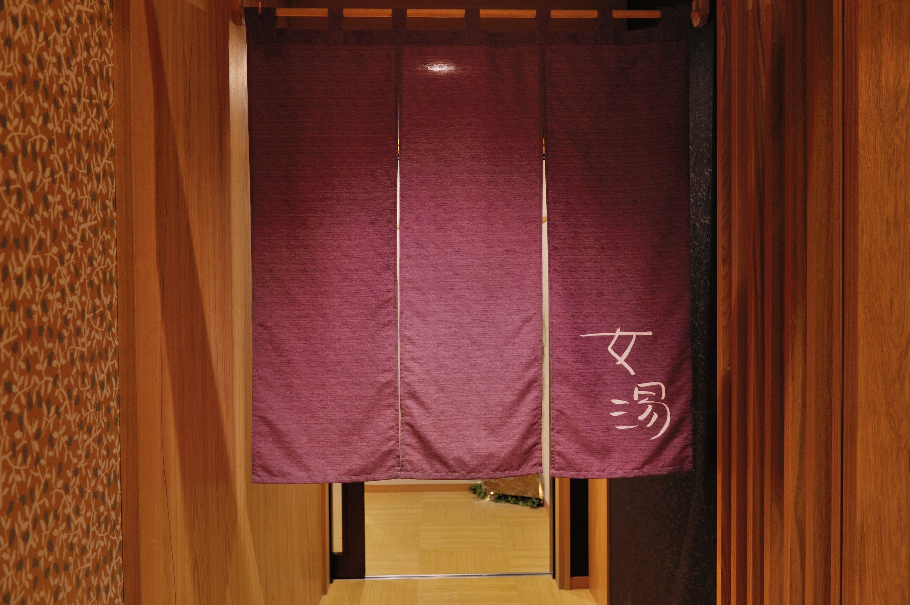 A traditional Japanese room with tatami flooring, a shoji screen, and a wooden door.