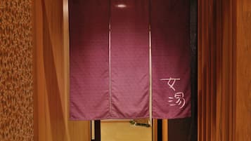 A traditional Japanese room with tatami flooring, a shoji screen, and a wooden door.
