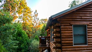 A log cabin with a wooden deck and a window. - Cozy Idyllwild Log Cabin w/ A/C & EV Charger (Idyllwild)