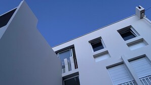 A modern building with a flat roof, multiple windows, and a visible door. - Between pine forest and ocean (Saint-Jean-De-Monts)