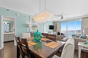 Enjoy meals with family and friends at the dining table, taking in the city view from the large window.