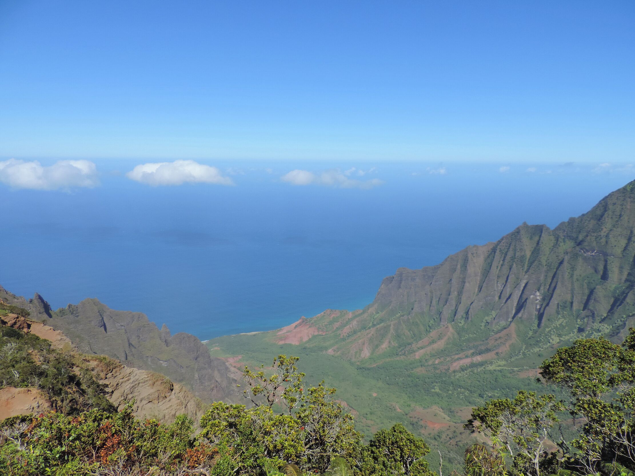A mountainous landscape with a view of the ocean.