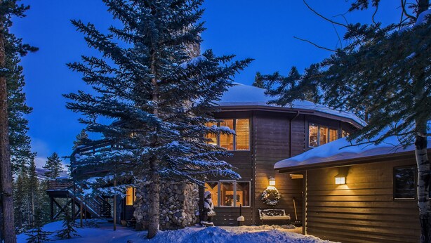 A wooden cabin with a stone wall, surrounded by snow-covered trees and a wooden deck. - Explore Colorado! VeryPrivate. Peaceful, AlpineLuxury on 3 Acres. 2 MilesToTown (Breckenridge)