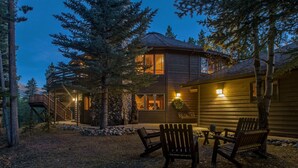 A cabin with a stone foundation, wooden exterior, and a deck with chairs. - Explore Colorado! VeryPrivate. Peaceful, AlpineLuxury on 3 Acres. 2 MilesToTown (Breckenridge)