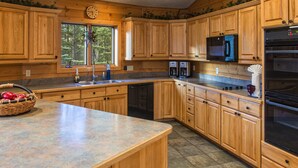 A kitchen with wooden cabinets, a microwave, a refrigerator, and a coffee maker. - Explore Colorado! VeryPrivate. Peaceful, AlpineLuxury on 3 Acres. 2 MilesToTown (Breckenridge)