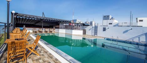 Outdoor pool, a rooftop pool, pool loungers
