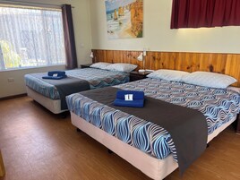 Family Room | Premium bedding, desk, laptop workspace, iron/ironing board