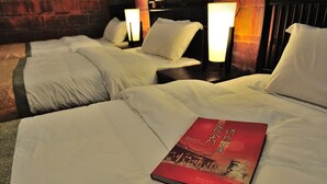 A hotel room with two beds, each with white linens and pillows, and a red book on the bed in the foreground. - Feng Mao Lin Zh (Jincheng)