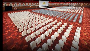 A large auditorium with rows of white chairs and a stage with a presentation screen. - Hotel Sunjoy9 Bandar Sunway (Petaling Jaya)