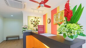 A reception desk with a 'RECEPTION' sign, a clock, and a 'WELCOME' sign. - Hotel Sunjoy9 Bandar Sunway (Petaling Jaya)