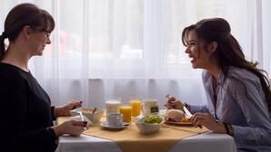 Two people dining at a table with breakfast items, including eggs, toast, and fruit. - B Gold Luxury Rooms (Split)