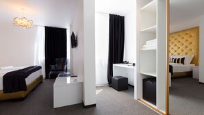 A modern hotel room with a bed, desk, wardrobe, and a mirror. - B Gold Luxury Rooms (Split)