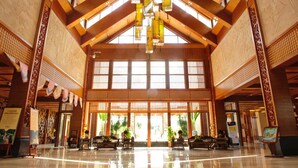 Un hall espacioso con techos altos, amplias ventanas y arquitectura de madera tradicional.