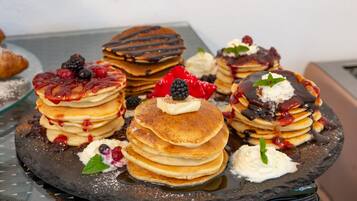A stack of pancakes with various toppings.