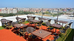 A rooftop terrace with outdoor seating, a clear view of the cityscape, and a red carpet. - Adranos Hotel (Bursa)
